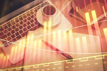 Stock market graph and top view computer on the table background. Multi exposure. Concept of financial education.