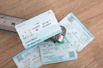 Several train tickets and a small green train model
