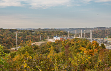 Overview of natural gas fracking pad near Moundsville West Virginia in the fall with autumn trees