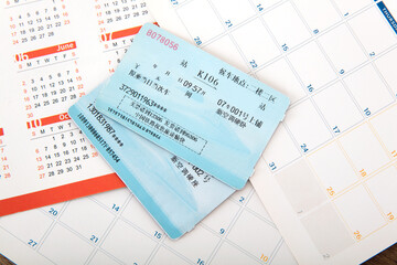 Two train tickets for the Spring Festival travel home on the desk calendar