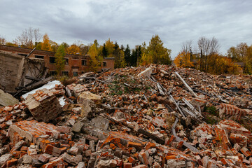 Remains of demolished old industrial building. Pile of stones, bricks and debris