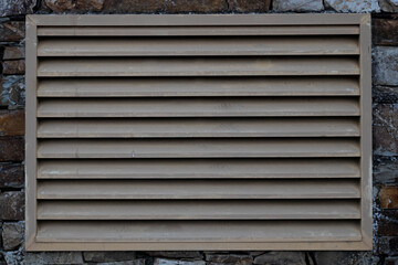 a ventilation grill outside of a factory