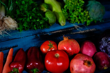 red and green fresh vegetables fruits on blue wood