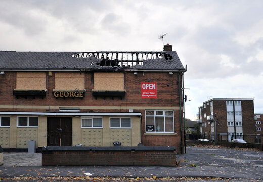 Leeds, England - September 24, 2017: A closed public house stands derelict and boarded on a housing estate in hunslet leeds after being attacked by vandals.