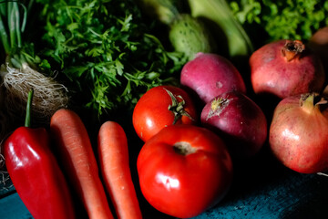 red and green fresh vegetables fruits on blue wood