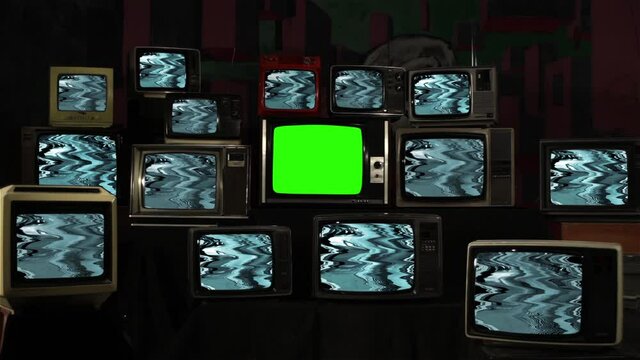 Stack of Old Television Sets with Glitch Pattern and One TV Green Screen. You can replace green screen with the footage or picture you want. You can do it with “Keying” effect in After Effects.