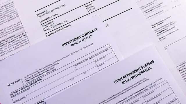 Conceptual composition. Pension savings. Blank form Investment contract 401(k) or 457 plan, blank form Utah retirement system 401(k), Personal 401k plan and GSEPS 401k plan Opt-Out form. Close-up