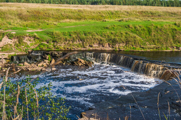 Fototapeta na wymiar Waterfall, water flowing from the river falls down