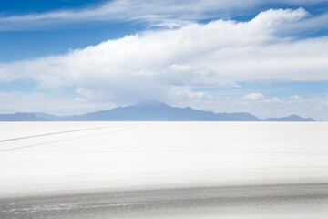 Volcano and clouds on the horizon of the salt flats in Bolivia
