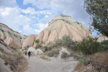Hikers on a trail near the surreal terrain at Cappadocia, Turkey