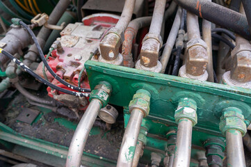 Old rusty vintage hydraulics: hydraulic pipes, pump, system of an aged machinery.