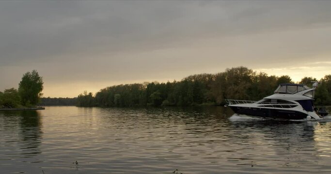 Yaht passing by Moscow river in sunset Serebrjannyj bor