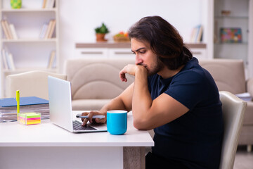 Young man employee working from house
