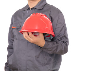 Construction worker holding a red hard hat in his hand