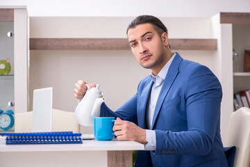 Young male employee working from the house