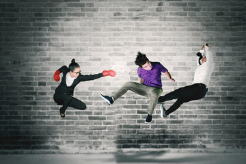 Young businesswoman punching her rivals