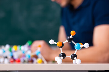 Young male scientist sitting in the classroom