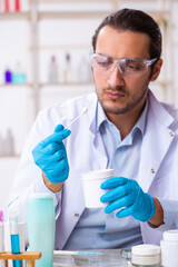 Young male chemist working in the lab