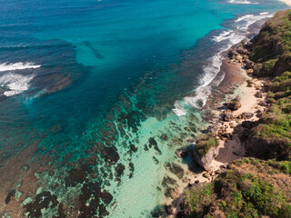 Obraz premium Top Aerial view from drone of impossible Beach in Bali, Indonesia. Clear blue aquamarine water during sunny day