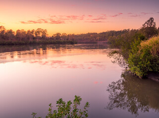 Fototapeta na wymiar Beautiful Riverside Sunrise with Cloud Reflections