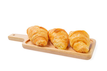 Croissants on wooden bread cutting board over white background with clipping path. Croissant french breakfast.
