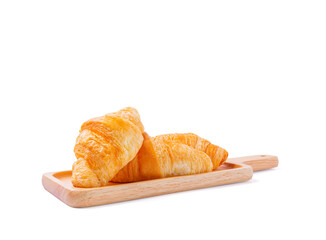 Croissants on wooden bread cutting board over white background with clipping path. Croissant french breakfast.