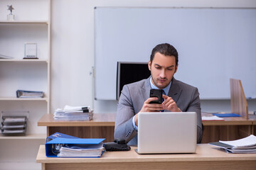 Fototapeta premium Young male businessman employee working in the office