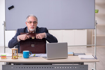 Old male teacher in the classroom