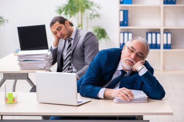 Two male employees working in the office