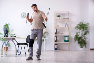 Young leg injured man with crutches