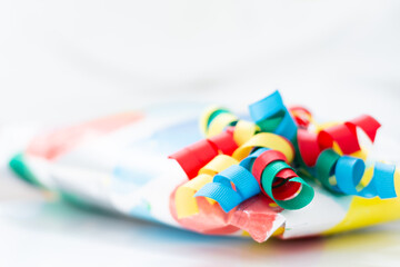 colourful ribbons on a wrapped gift with a white background