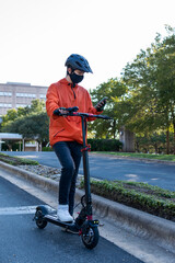 Boy on scooter checks his phone
