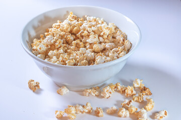 White bowl with sweet popcorn on white background