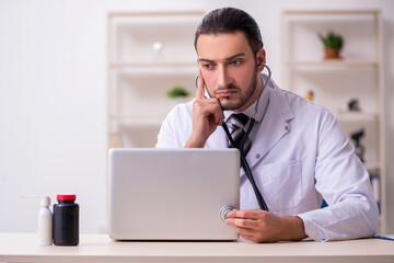 Young male doctor working in the clinic