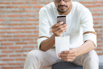 Young man using smartphone scan QR code or Bar code with  mobile banking application to payment bill, 