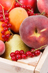 Fresh ripe fruits in wooden box. Food containing healthy minerals and vitamins
