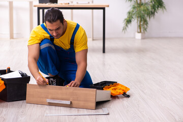 Young male carpenter working indoors