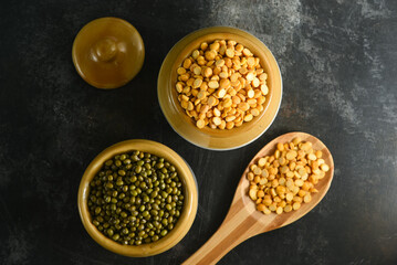 Various sources of vegetable protein beans, lentils, peas, chickpeas, mung bean in bowls. Indian Pulses uncooked , Lentils, Rice healthy balanced diet for vegans and vegetarians. Legumes assortment