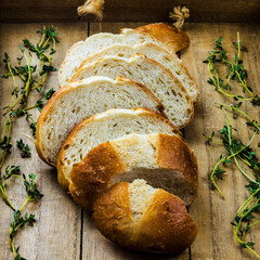 bread and fresh thyme on wooden board