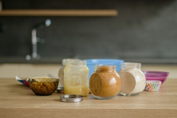 Preparations for baking sweets (from flour, flakes, cane sugar, nuts, butter and chocolate) for a birthday party in a modern, new kitchen