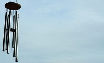 Hanging mobile with a silver metal stick hanging on it.