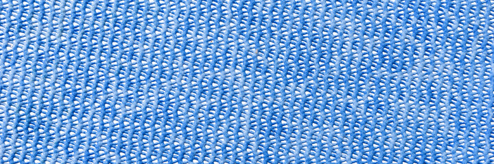 Blue plastic background with holes. Panoramic blue pattern