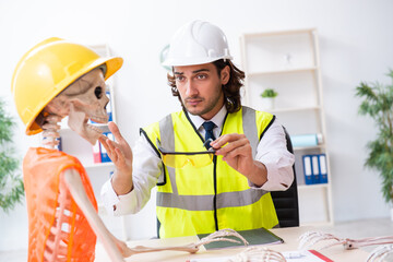 Funny construction business meeting with boss and skeletons