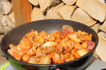 goulash with carrots and onions in a pan