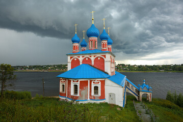 The old church of the Kazan Icon of the Mother of God over the stormy sky. Tutaev, Russia