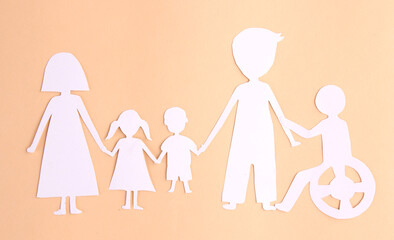 paper family cutout on yellow background.