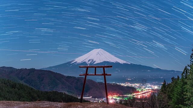 Mt Fuji under a full moon with Torri gate and star trails timelapse