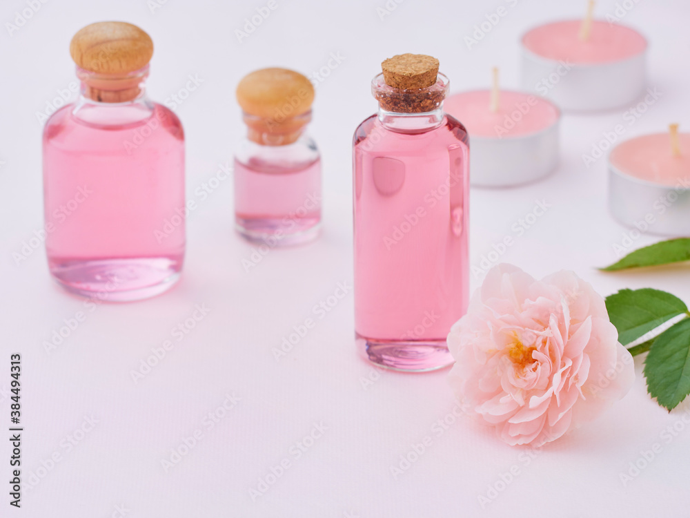 Wall mural aromatherapy oil bottles and pink rose