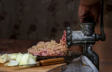 Cooking healthy minced meat,onions and spices in a meat grinder by hand.