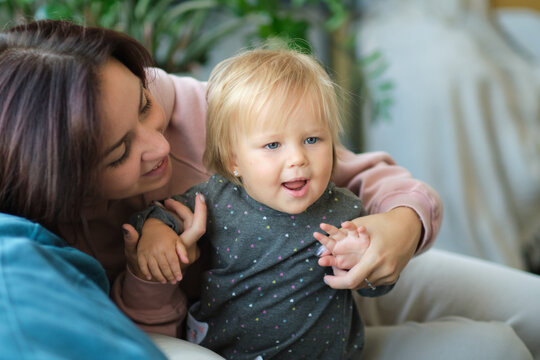 Happy loving family. mother and child girl playing, kissing and hugging